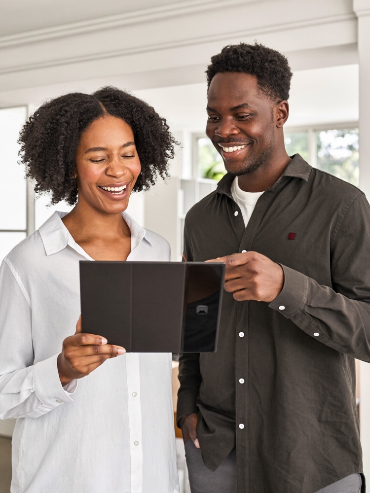 Two business partners checking their numbers on a tablet